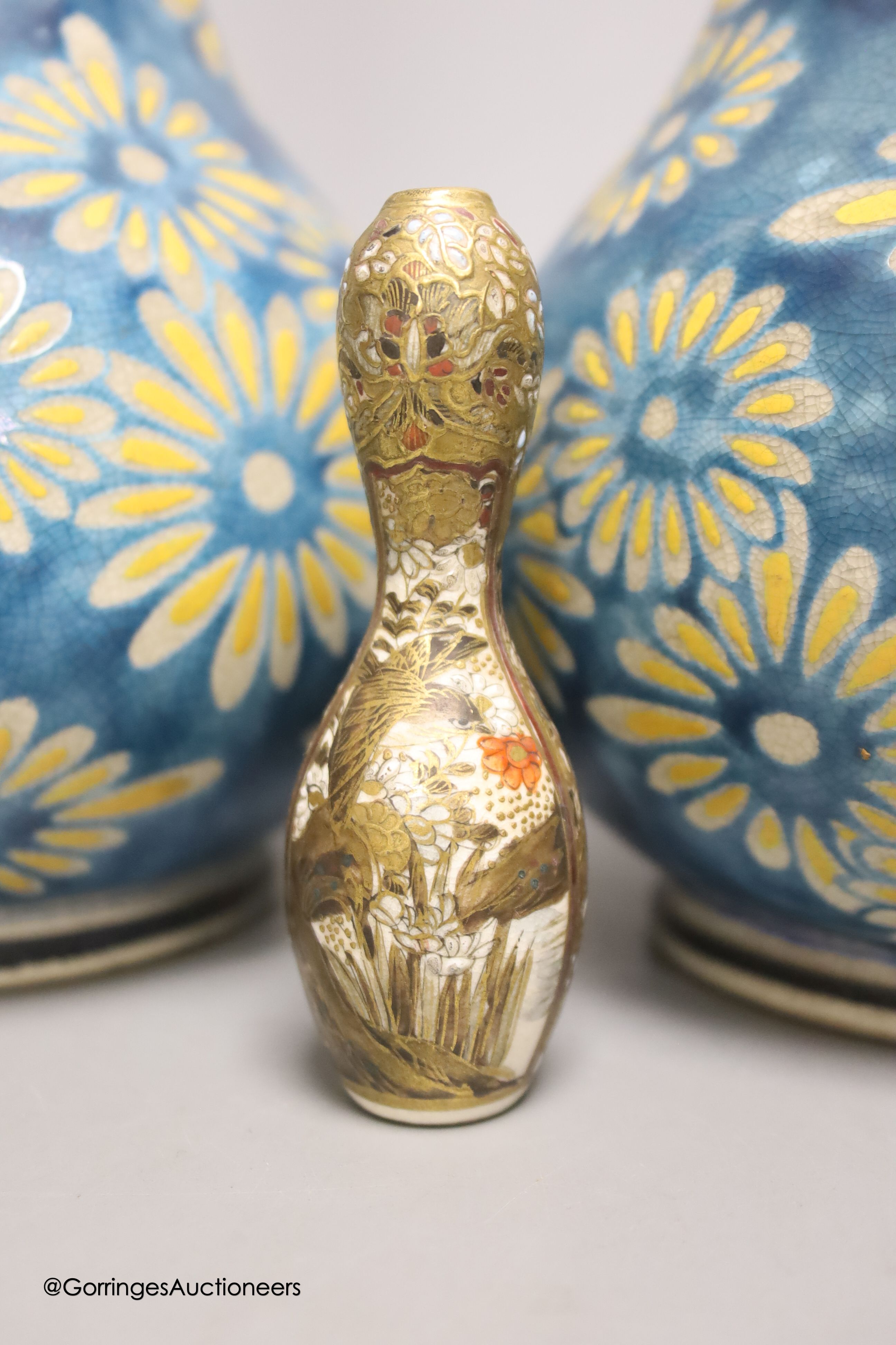 A pair of Japanese Satsuma pottery bottle vases by Taizan Yohei IX, 30cm and a miniature Satsuma vase